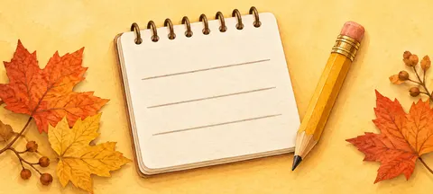 Spiral notepad and pencil among autumn leaves